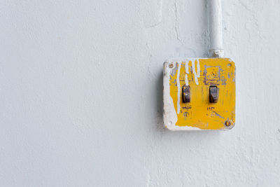 Close-up of telephone booth on wall