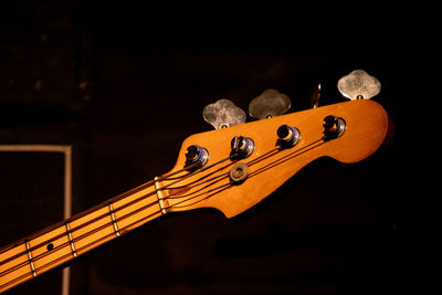 Close-up of guitar against black background