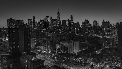 High angle view of illuminated buildings against sky at night