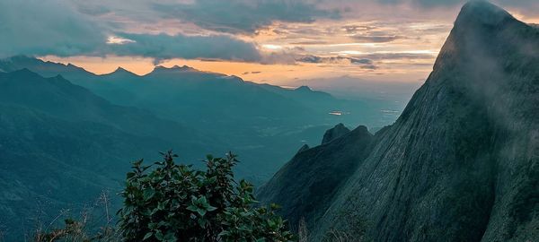 Scenic view of mountains against sky at sunset