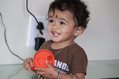 Portrait of smiling boy holding camera