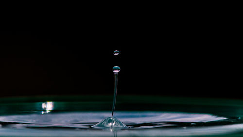Close-up of water splashing against black background