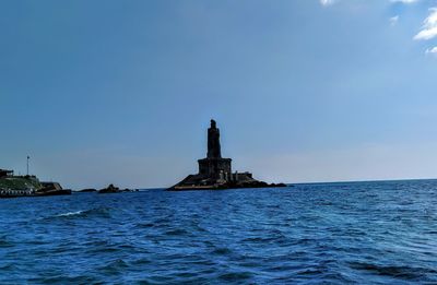 Lighthouse on building by sea