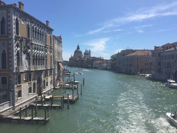 Santa maria della salute by grand canal in city against sky