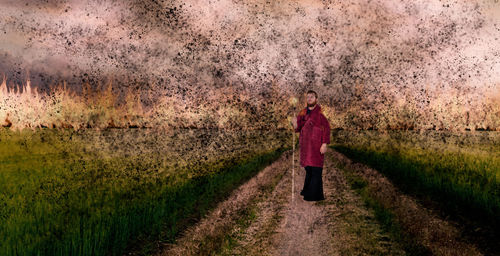 Rear view of a man walking on field