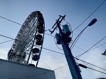 Low angle view of ferris wheel against sky