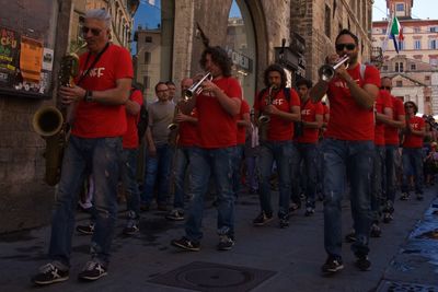 Group of men playing trumpet on street