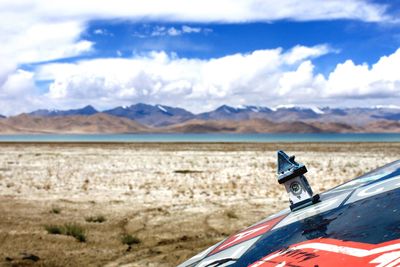 Car on mountain against sky