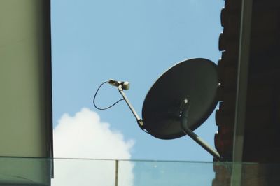 Close-up of electric lamp against sky