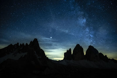 Scenic view of mountains against sky at night