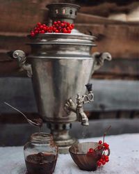 Container with cherries on table