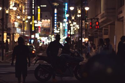 People walking on road along buildings