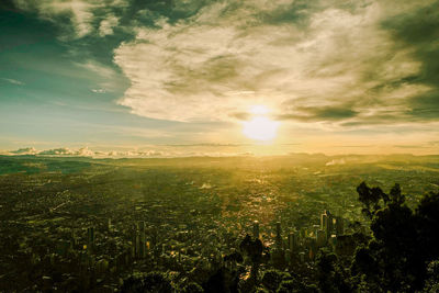 Aerial view of city against sky during sunset