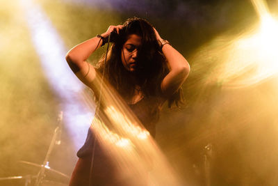 Woman by microphone at stage