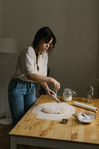 Young woman making christmas cookies