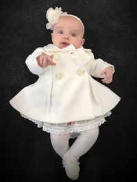 High angle view of cute baby girl against black background