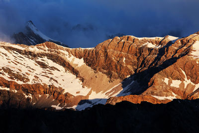 Scenic view of mountains against cloudy sky