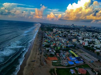 High angle view of buildings by sea against sky