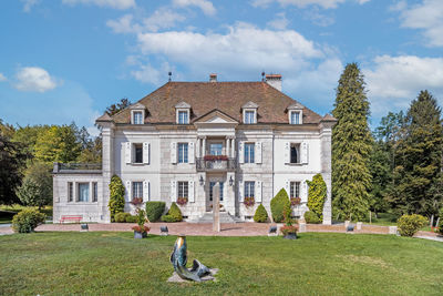 Lawn by building against sky