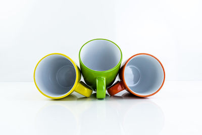 Close-up of multi colored coffee cup on table