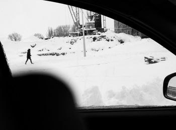 Man in car on snow covered road