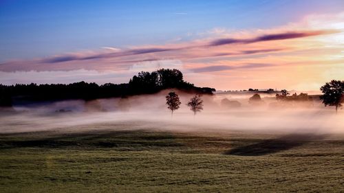 Scenic view of landscape against sky at sunset