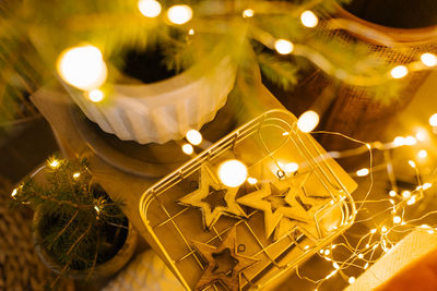 Christmas tree toys wooden stars in a basket with lights. festive decor