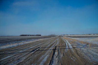 Dirt road against clear sky