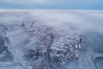 High angle view of cityscape against cloudy sky