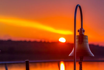 Close-up of bell at sunset