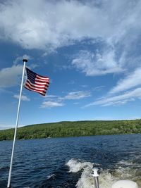 Flag on pole against blue sky