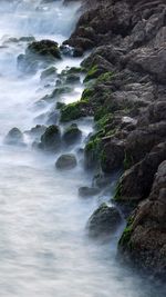 Scenic view of waterfall in foggy weather