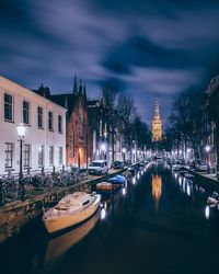 Boats moored on canal in city