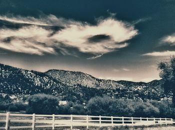 Scenic view of mountains against cloudy sky