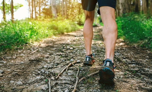 Low section of man running on road