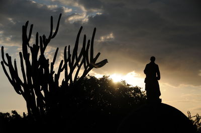 Low angle view of silhouette statue against sky during sunset