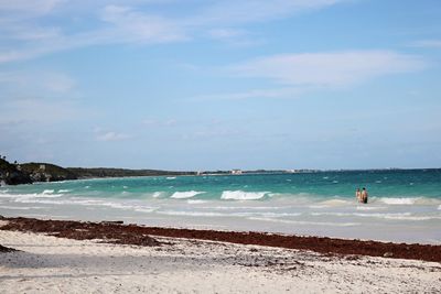 View of beach against cloudy sky