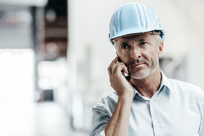 Midsection of man working with mobile phone