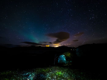 Scenic view of illuminated mountain against sky at night