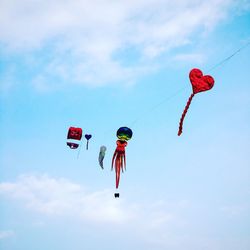 Low angle view of parachute against blue sky