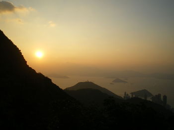 Scenic view of silhouette mountains against sky during sunset