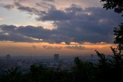 Scenic view of buildings against sky during sunset