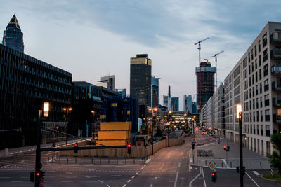 City street and buildings against sky at dusk in frankfurt, germany 