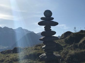 Stack of stones on mountain against sky