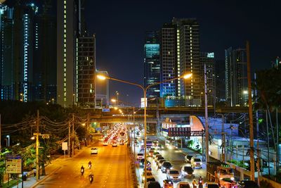 High angle view of illuminated street and buildings at night