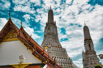 Low angle view of buildings against cloudy sky