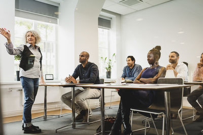 Teacher explaining multi-ethnic students in language class