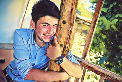 Portrait of a smiling young man sitting outdoors