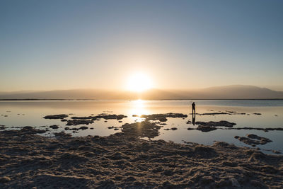 Scenic view of sea against clear sky during sunset