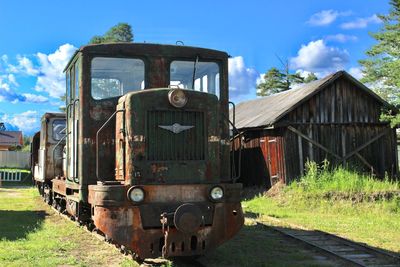 Abandoned train on railroad track against sky